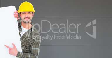 Worker wearing hardhat while pointing at blank bill board