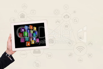 Cropped image of hand holding various icons in digital tablet with symbols in background