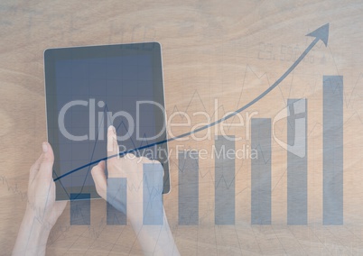 Overhead of hands with tablet and blue graph overlay