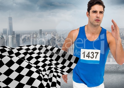 Male runner sprinting against skyline and checkered flag
