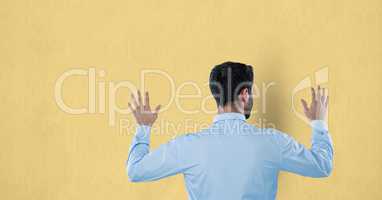Rear view of businessman touching wall