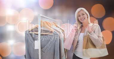 Happy woman shopping over bokeh