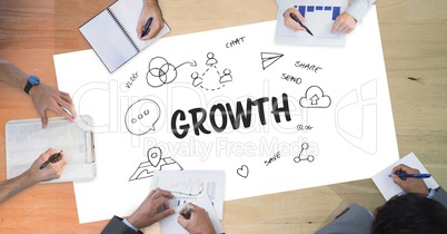 Growth text by icons and business people on table