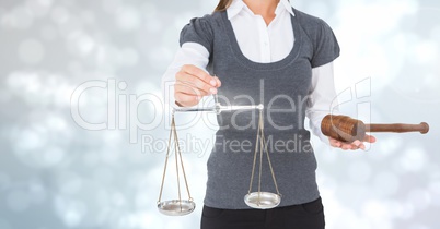 Judge with balance scale and hammer in front of lights