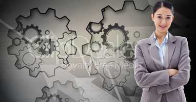 Digital composite image of businesswoman with gears in background