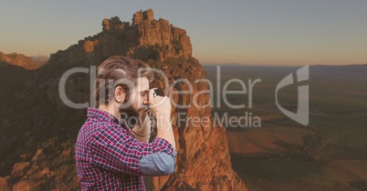 mountain travel, man taking a photo in the montain