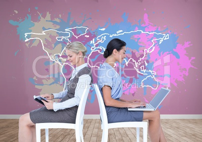 Businesswomen collaborating working in front of Colorful Map with paint splattered wall background
