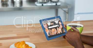 Hands holding tablet PC with search screen and coffee cup