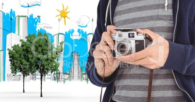 Digitally generated image of male tourist holding camera with buildings drawn in background