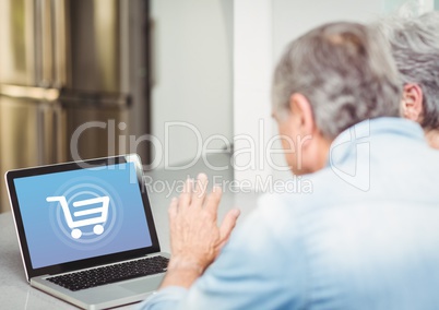 Old people using laptop with Shopping trolley icon