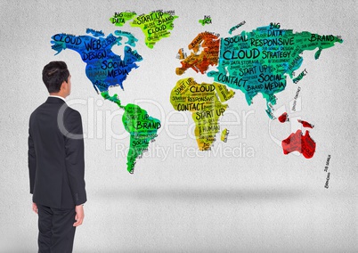 Businessman looking at Colorful Map floating in bright room