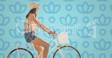 Woman on bike against blue floral pattern