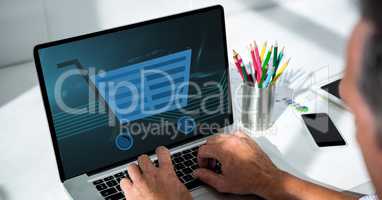 Cropped image of man using laptop with shopping cart icon on screen