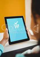 Woman using Tablet with Shopping trolley icon