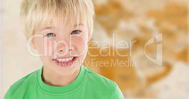 Boy smiling against blurry brown map
