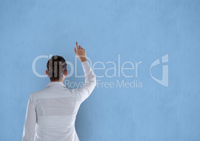 Rear view of businesswoman pointing on blue background