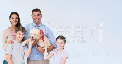 Portrait of happy family with dog against gray background