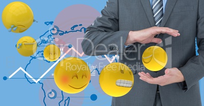 Digital composite image of businessmen holding flying emojis with tech graphics in background