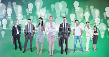Digital composite image of image of business people with light bulbs flying in background