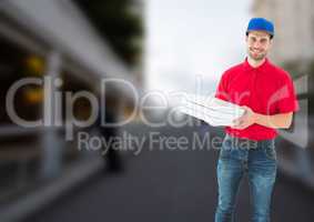 Happy deliveryman with pizza boxes in a bridge
