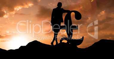Silhouette businesswoman leaning n pound sign during sunset