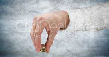 Hand with coins against blue grunge background