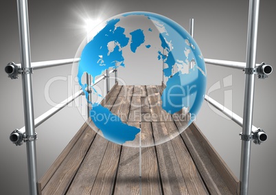Globe with flare on scaffolding against grey background