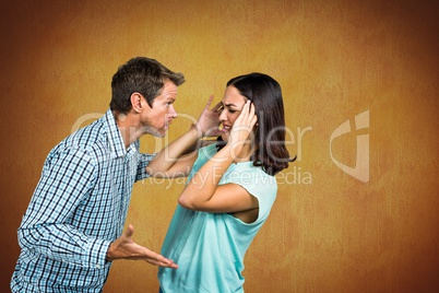 Couple fighting against yellow background