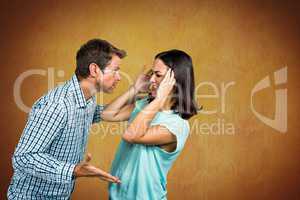 Couple fighting against yellow background