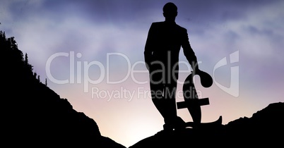 Silhouette of businessman with pound sign on mountain