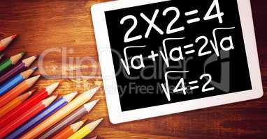 High angle view of various mathematical formula by color pencils on wooden table