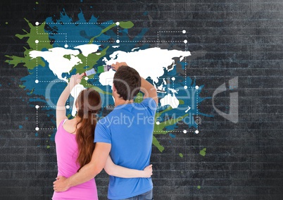 Couple painting a Colorful Map with paint splatters on wall background