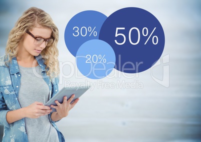 Woman with tablet and blue statistics against blurry blue wood panel