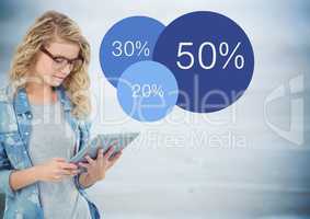 Woman with tablet and blue statistics against blurry blue wood panel