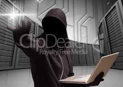 Anonymous Criminal in hood with laptop in front of servers