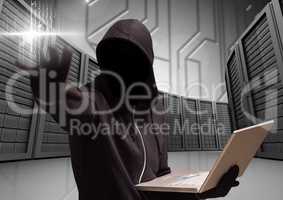 Anonymous Criminal in hood with laptop in front of servers