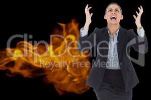 Digital composite image of angry businesswoman screaming with fire in background