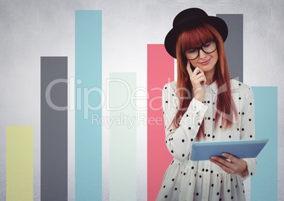 Woman in hat with tablet against colourful graphs against white wall