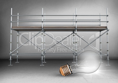 Lightbulb in front of scaffolding in grey room