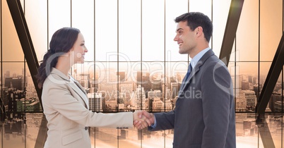 Side view of male and female professionals shaking hands