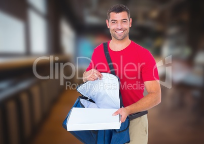Happy deliveryman with delivery bag and pizza boxes in the city at night