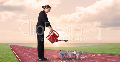 Businesswoman watering employees on running tracks against cloudy sky