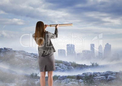 Business woman observing skyline with telescope from misty mountain peak