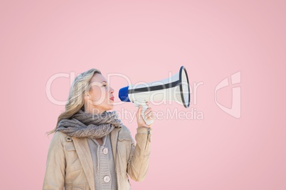 Woman in warm clothing talking in megaphone