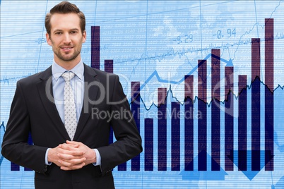 Portrait of businessman standing against graphs on interface graphics