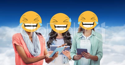 Digitally generated image of female  friends faces covered with emoji using digital tablet against s