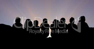 Silhouette children sitting against sky