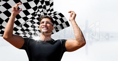 Male runner with hands in air against white skyline and checkered flag