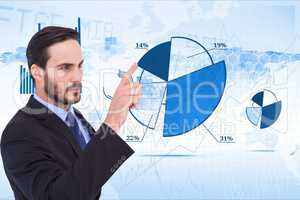 Digital composite image of businessman touching pie chart against tech graphics