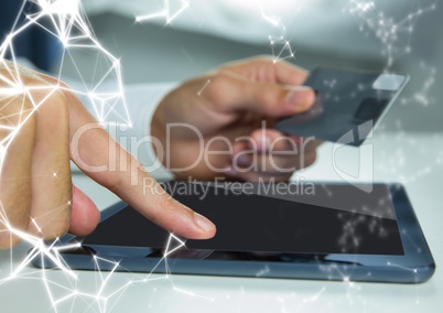 Hands with tablet and credit card and white network overlay